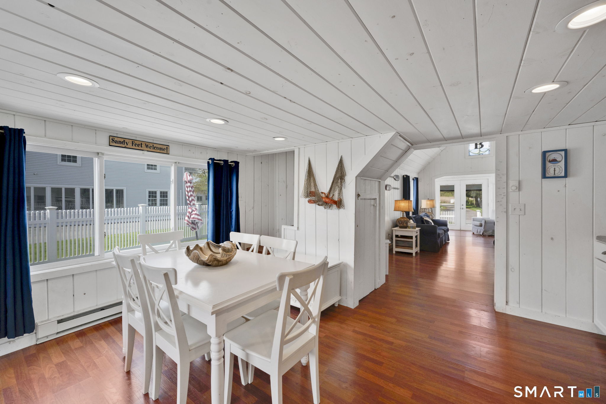 96 Chalker Beach Road Old Saybrook, CT 06475 - Photo 15 of 33 a view of a dining room with furniture window and wooden floor