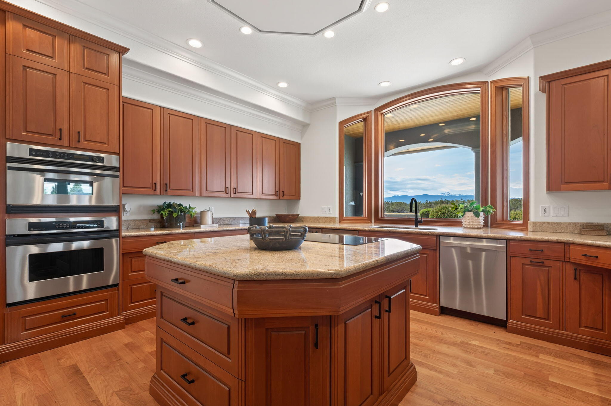 20180 Winston Loop Bend, OR 97703 - Photo 13 of 59 a kitchen with stainless steel appliances granite countertop a sink a stove and a wooden cabinets