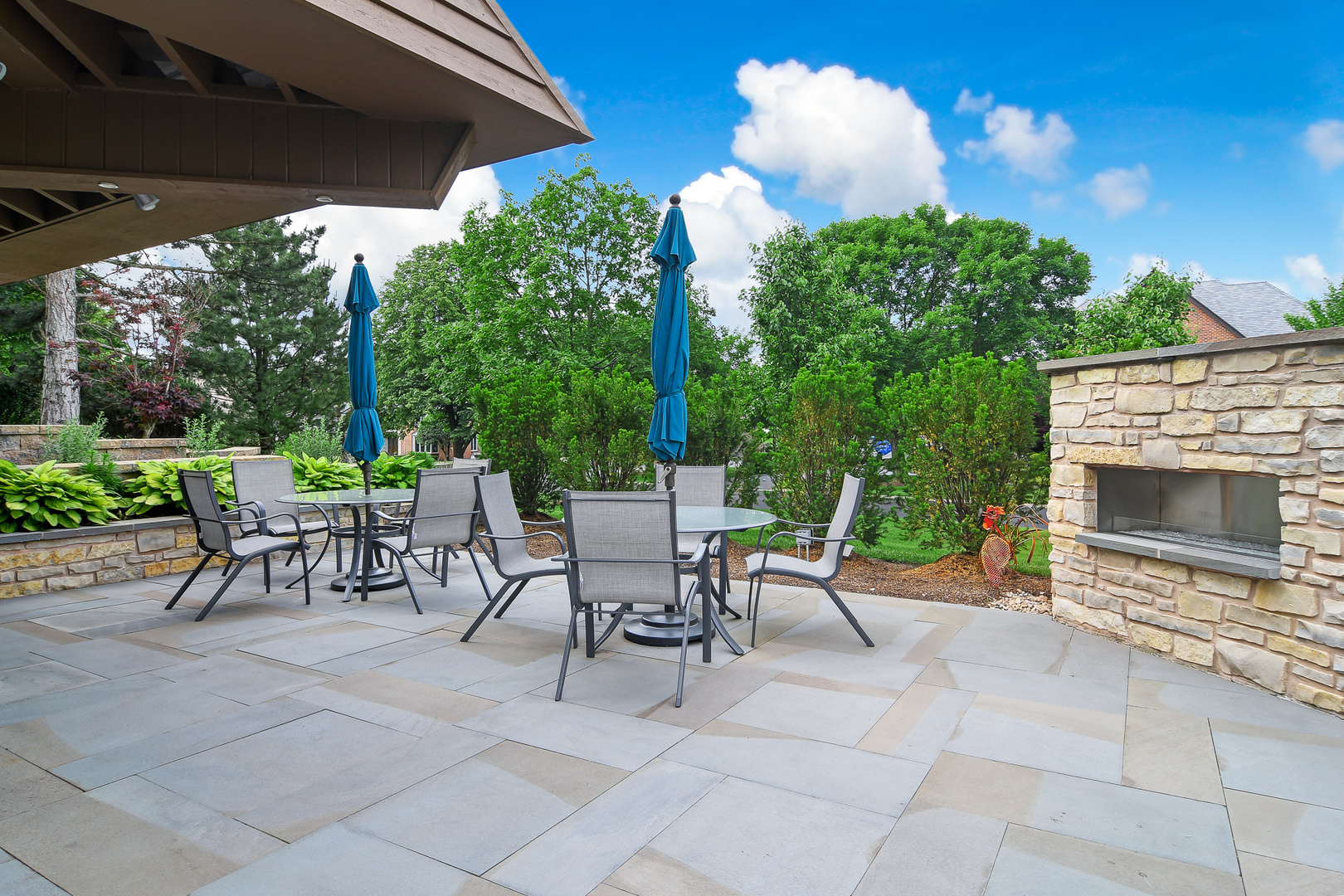 39 Fawn Court Burr Ridge, IL 60527 - Photo 37 of 46 a view of a patio with a table and chairs under an umbrella