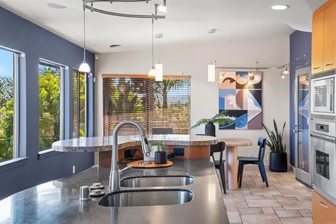 a living room with furniture and kitchen view