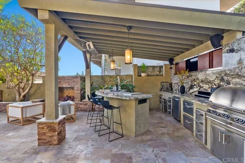 a room with lots of white furniture and a large window