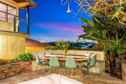 a kitchen with stainless steel appliances granite countertop table chairs and a large window