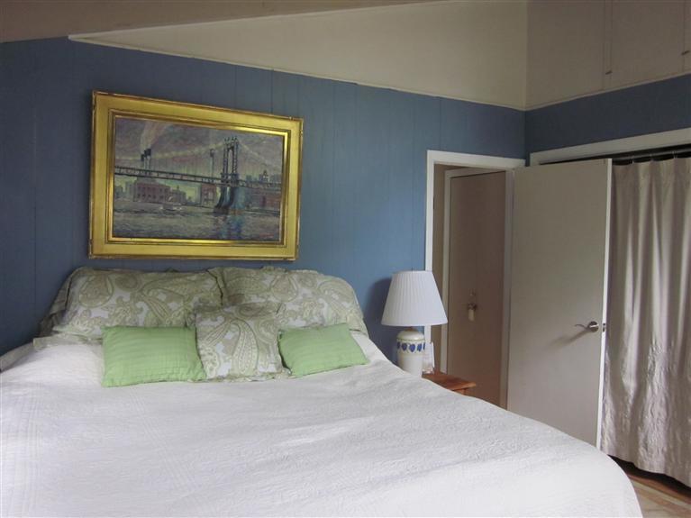 151 Cove View Road Wellfleet, MA 02667 - Photo 13 of 32 a bedroom with a bed and a painting on the wall