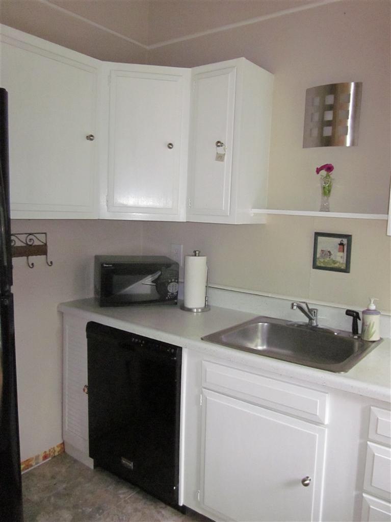 151 Cove View Road Wellfleet, MA 02667 - Photo 23 of 32 a kitchen with a sink and cabinets