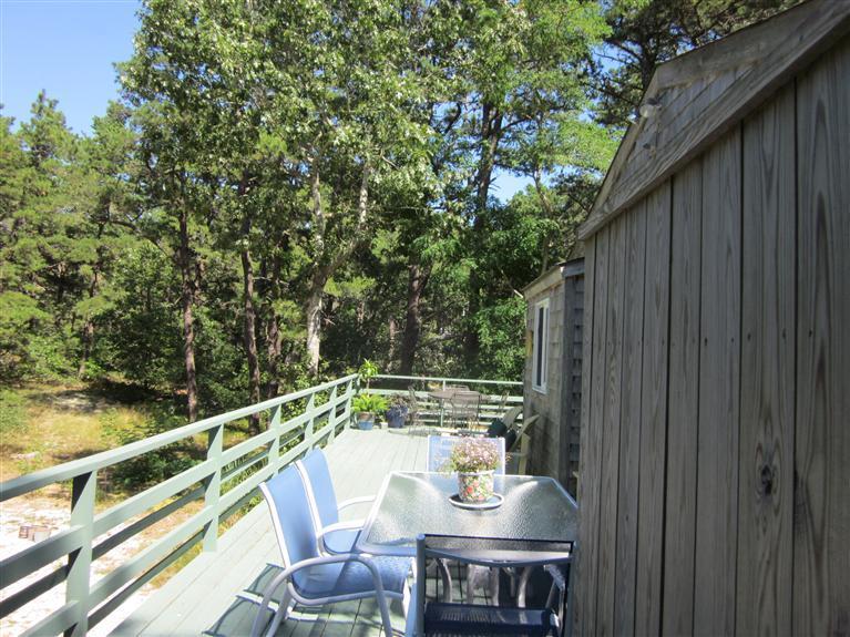 151 Cove View Road Wellfleet, MA 02667 - Photo 28 of 32 a balcony with wooden floor and outdoor seating