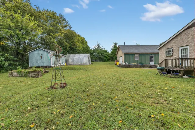 a swimming pool with lots of tress in front of it