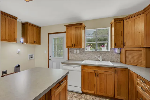 a kitchen with a sink a stove and cabinets