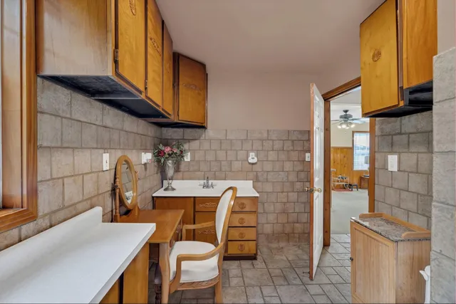 a bathroom with a sink a toilet and mirror