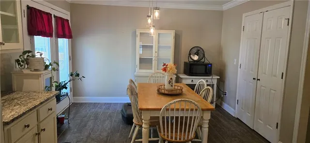 a view of a room that has a bed and a dresser in it