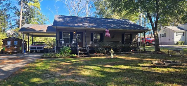 a view of a house with backyard porch and sitting area