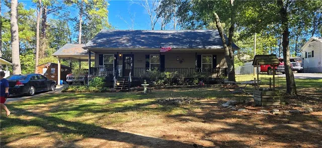 a view of a chairs and table in the backyard