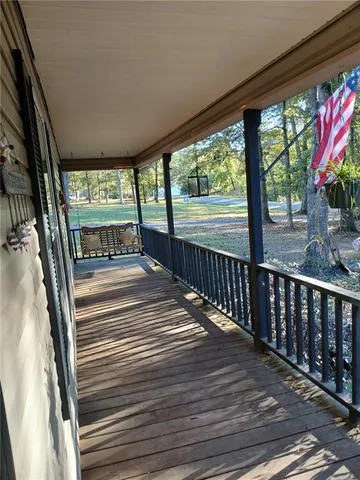 a view of a porch with wooden floor and stairs