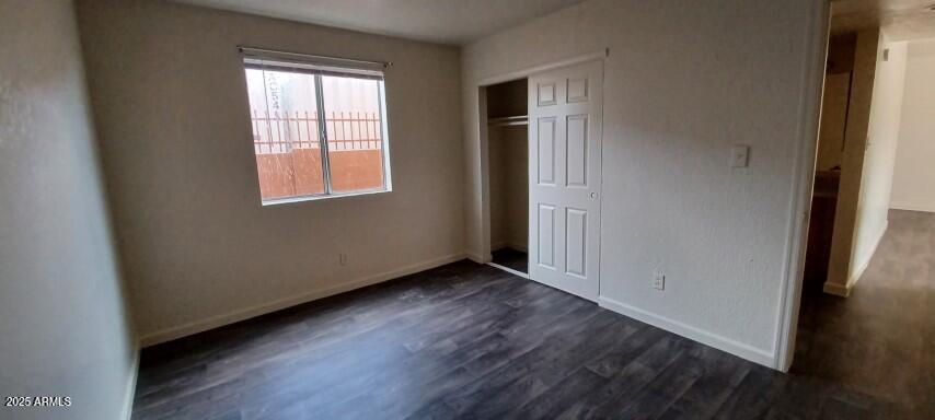 2537 West Georgia Avenue, Unit 2 Phoenix, AZ 85017 - Photo 13 of 14 an empty room with wooden floor and windows