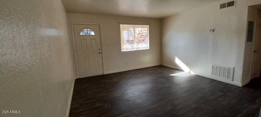 2537 West Georgia Avenue, Unit 2 Phoenix, AZ 85017 - Photo 3 of 14 an empty room with wooden floor and windows