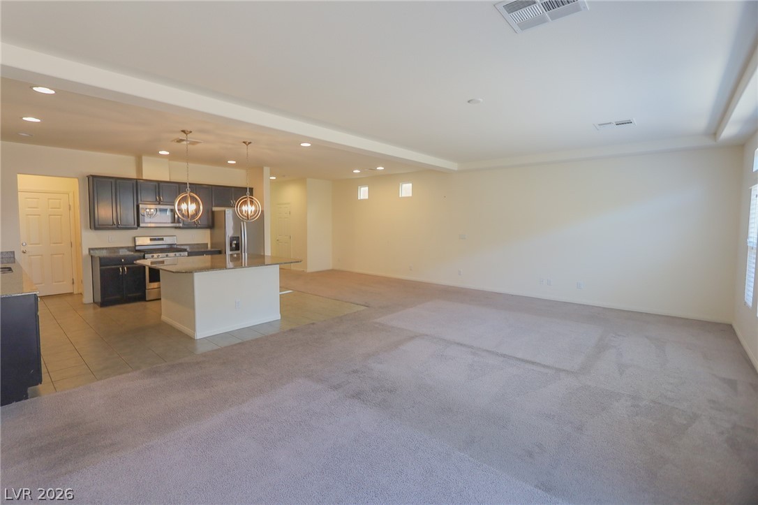 6418 Jackson Spring Road Las Vegas, NV 89118 - Photo 20 of 20 An open floorplan seamlessly connects the well-appointed kitchen to the spacious living area, ideal for entertaining.