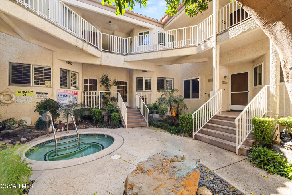 a front view of a house with a yard and potted plants