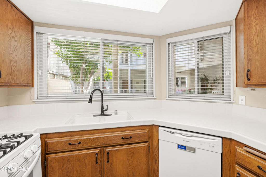 3354 Darby Street, Unit 313 Simi Valley, CA 93063 - Photo 13 of 30 a view of a kitchen with a sink and cabinets