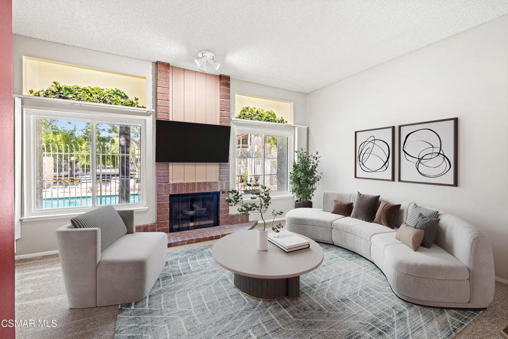 3354 Darby Street, Unit 313 Simi Valley, CA 93063 - Photo 17 of 30 a living room with furniture a fireplace and a large window