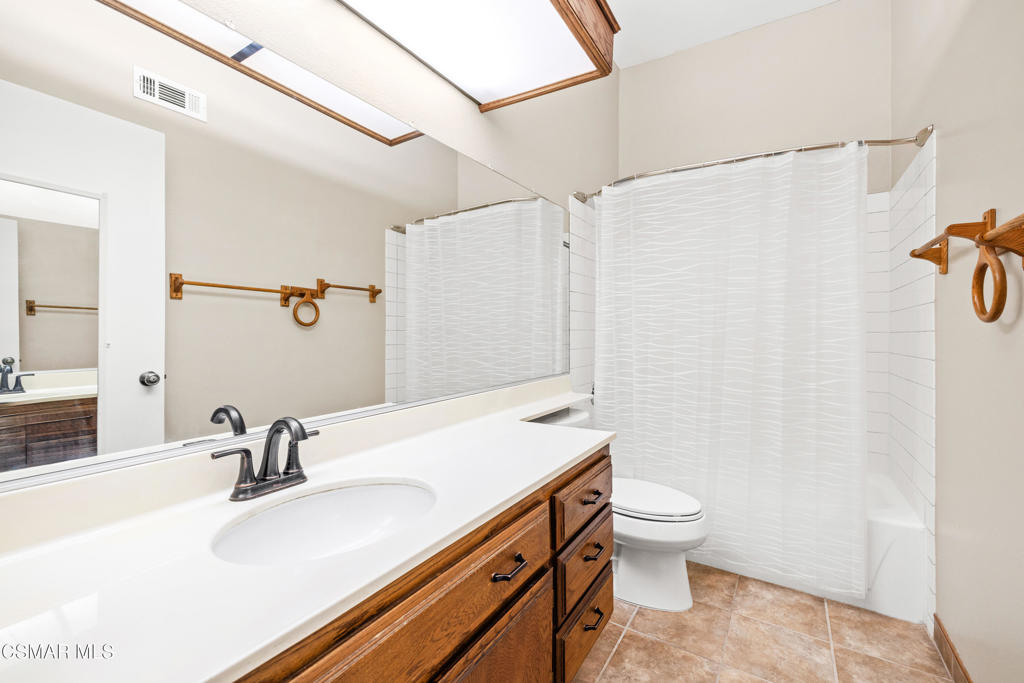 3354 Darby Street, Unit 313 Simi Valley, CA 93063 - Photo 27 of 30 a bathroom with a sink a toilet and a mirror