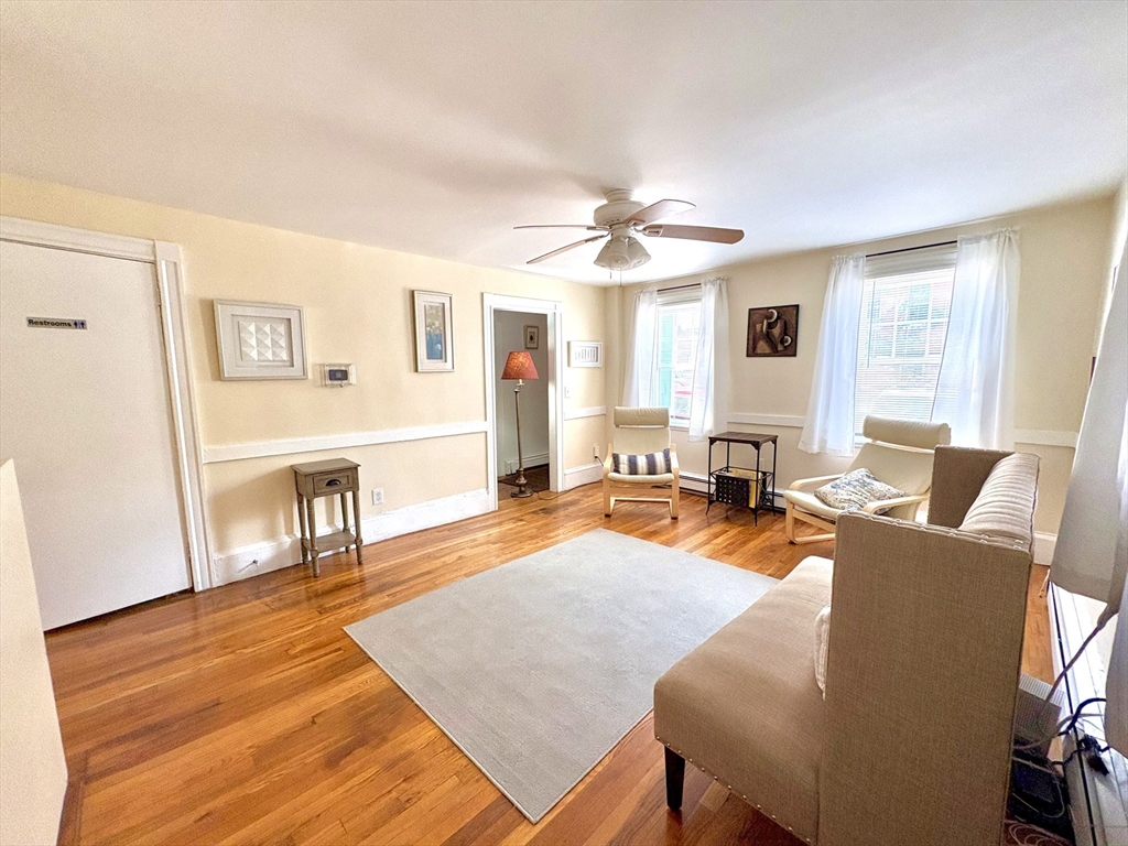 285 Roxbury Street Boston, MA 02119 - Photo 2 of 15 a living room with furniture and a wooden floor