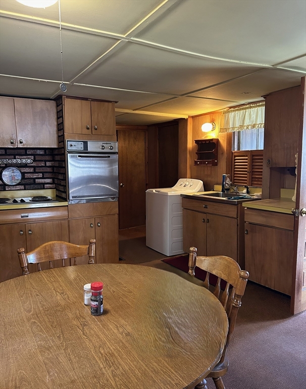 1386 Pleasant Street Athol, MA 01331 - Photo 6 of 11 a kitchen with a sink and cabinets