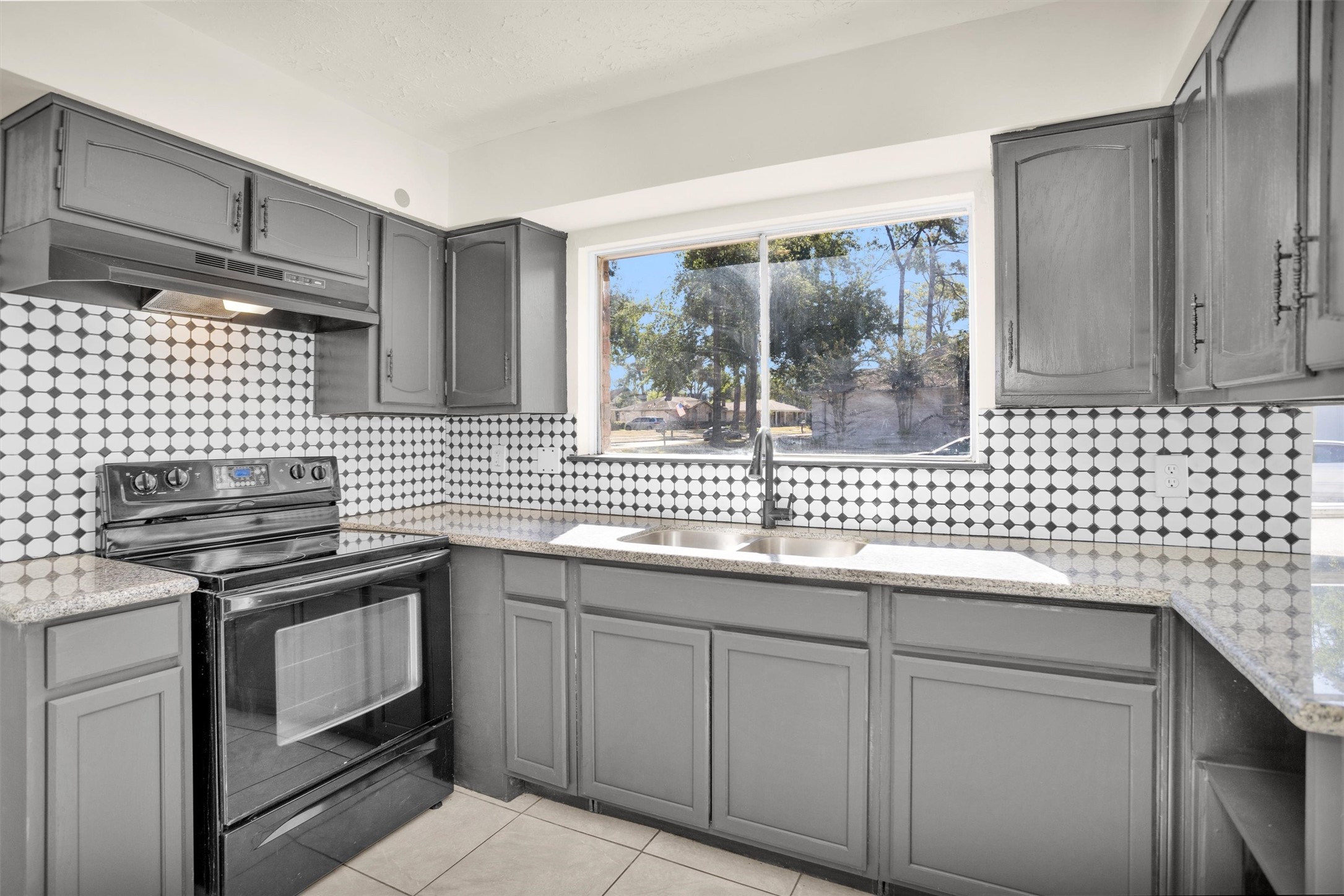 2126 Millhouse Road Houston, TX 77073 - Photo 3 of 30 a kitchen with a sink cabinets and stainless steel appliances