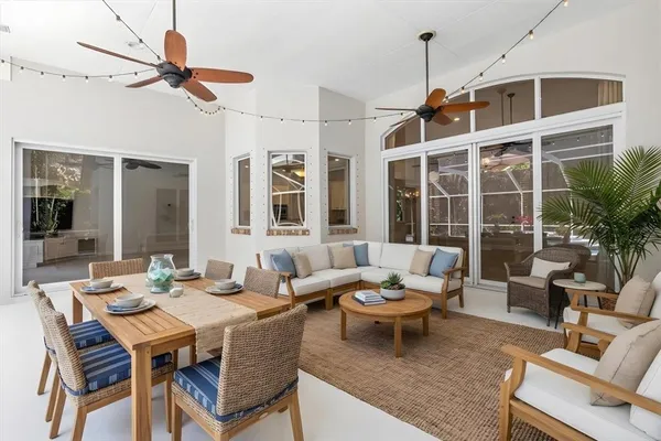 a living room with furniture a window and a ceiling fan