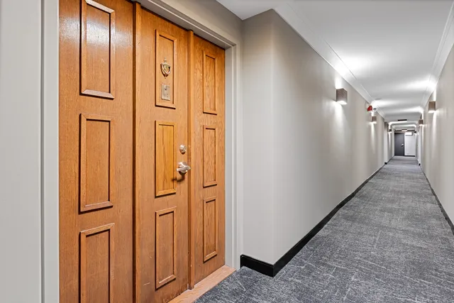 a view of a hallway with wooden floor