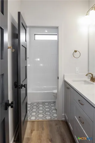 a bathroom with a shower and a sink