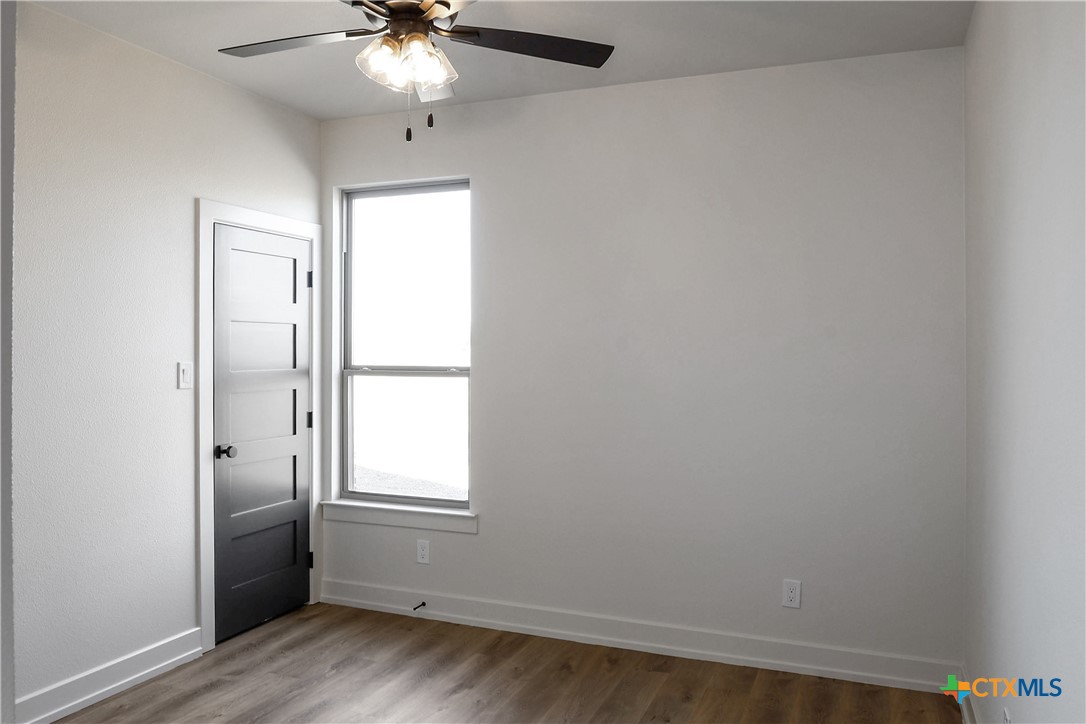 16026 Honey Ridge Drive Holland, TX 76534 - Photo 14 of 27 an empty room with a window and a chandelier