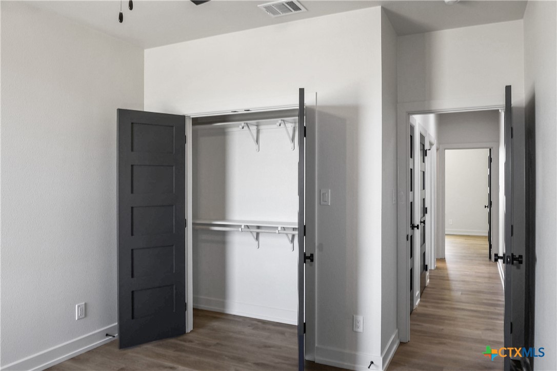 16026 Honey Ridge Drive Holland, TX 76534 - Photo 16 of 27 a view of walk in closet with wooden floor