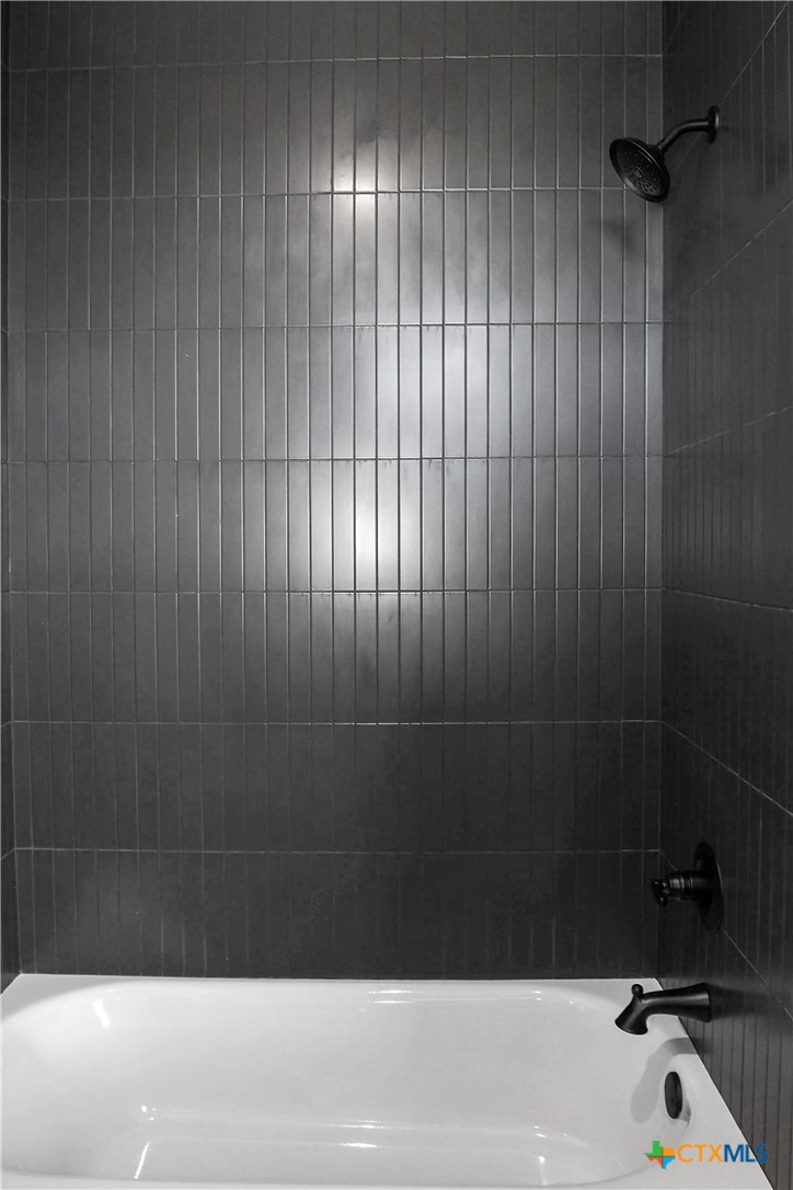 16026 Honey Ridge Drive Holland, TX 76534 - Photo 18 of 27 a bathroom with a bathtub and a shower