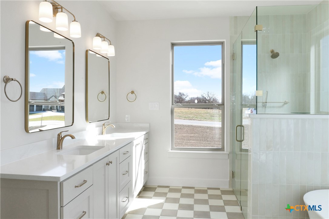 16026 Honey Ridge Drive Holland, TX 76534 - Photo 20 of 27 a spacious bathroom with a double vanity sink toilet mirror and shower