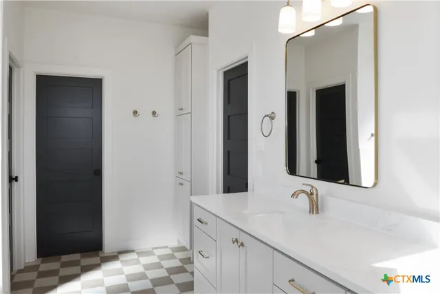 a bathroom with a sink and a mirror