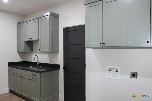 a kitchen with a sink and cabinets