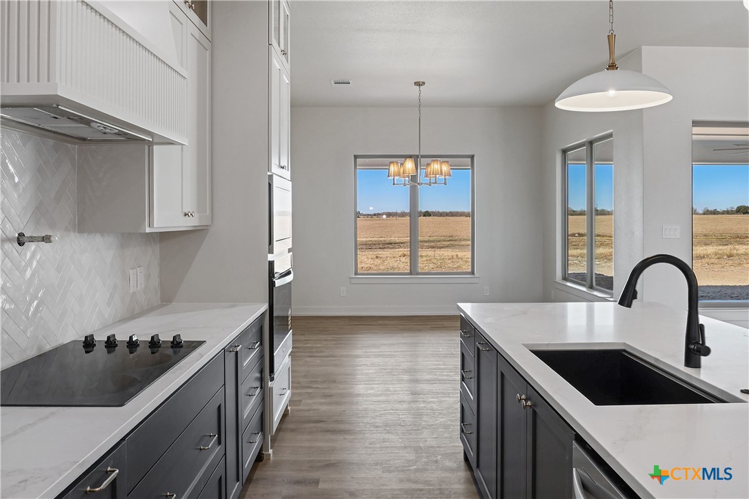 16026 Honey Ridge Drive Holland, TX 76534 - Photo 5 of 27 a kitchen with kitchen island a sink stove top oven and cabinets