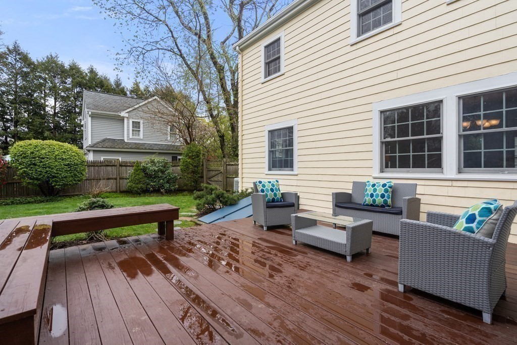 41 Janet Road Newton, MA 02459 - Photo 32 of 37 a view of a deck with couches table and chairs with wooden floor and fence