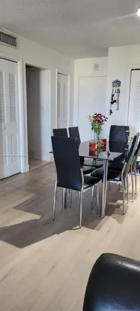 a dining room with furniture and wooden floor