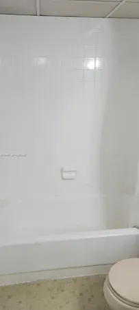 a bathroom with a toilet and a bathtub