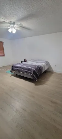 a bedroom with a bed and chandelier