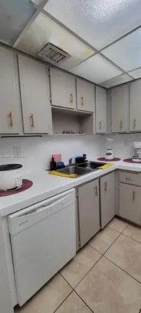 a kitchen with cabinets appliances a sink and a counter top