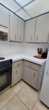 a kitchen with cabinets and appliances