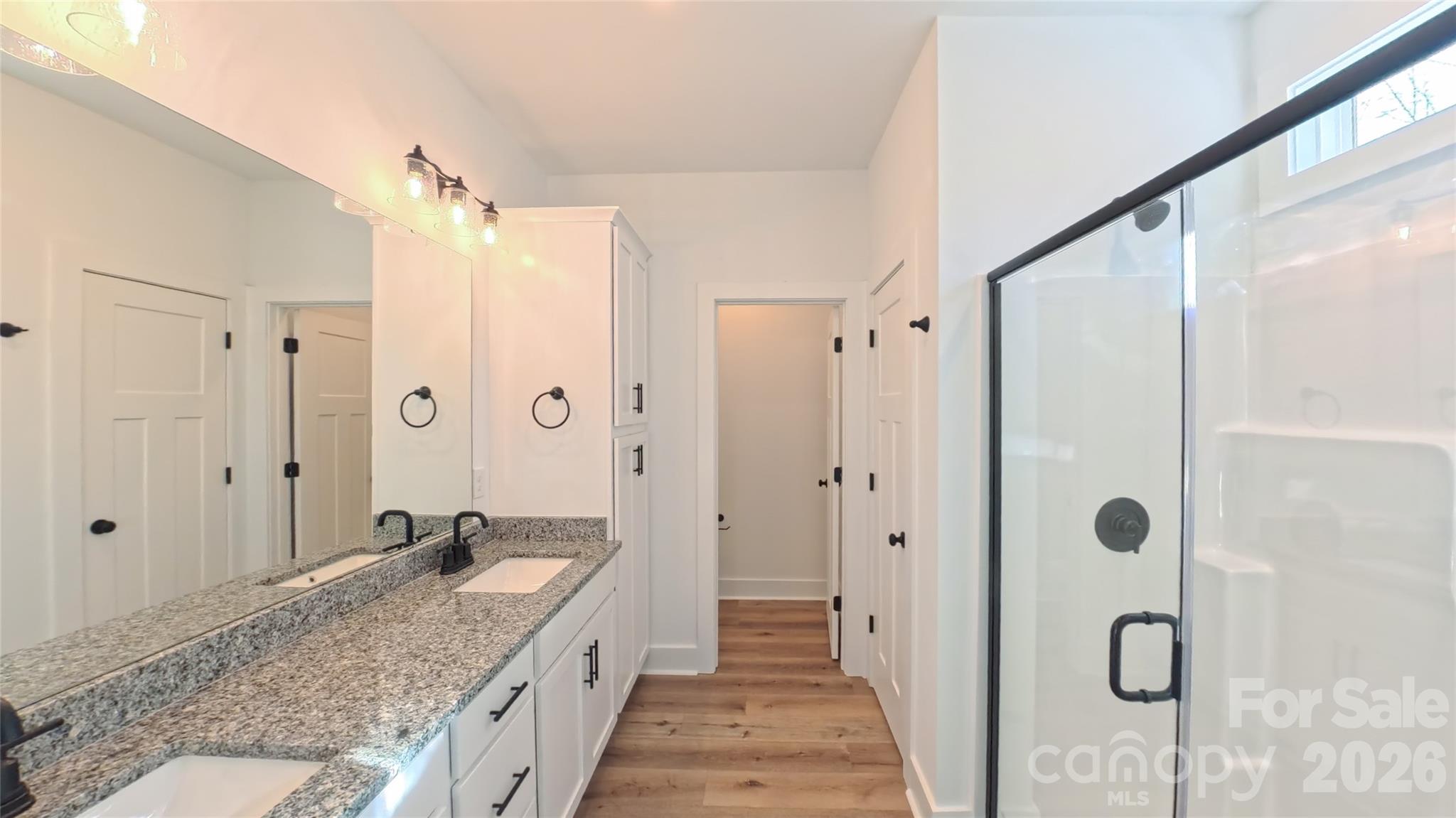 4018 Deerstone Lane Clover, SC 29710 - Photo 17 of 35 a bathroom with a granite countertop sink a mirror a shower and a tub