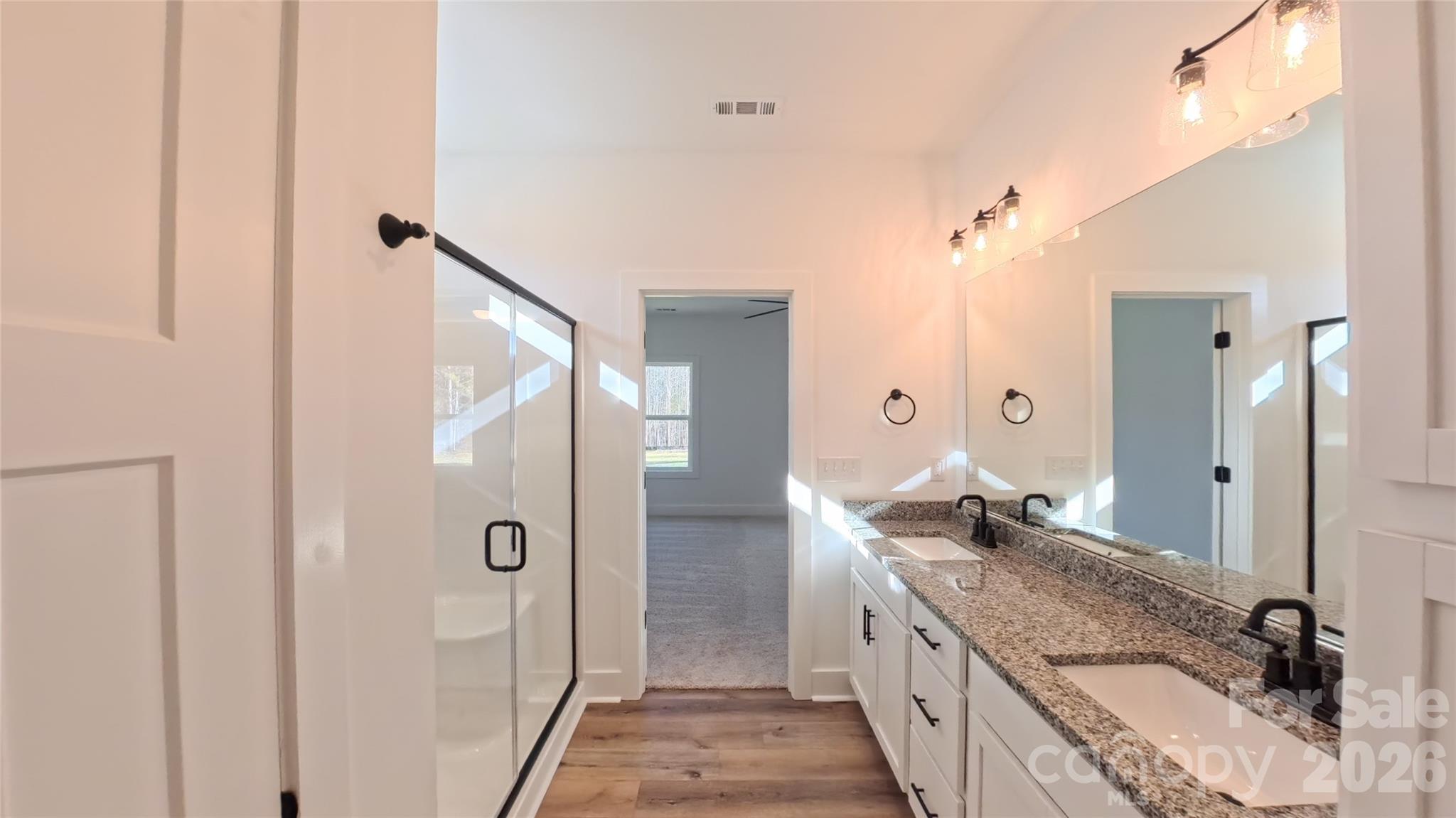 4018 Deerstone Lane Clover, SC 29710 - Photo 18 of 35 a spacious bathroom with a granite countertop sink a mirror and shower