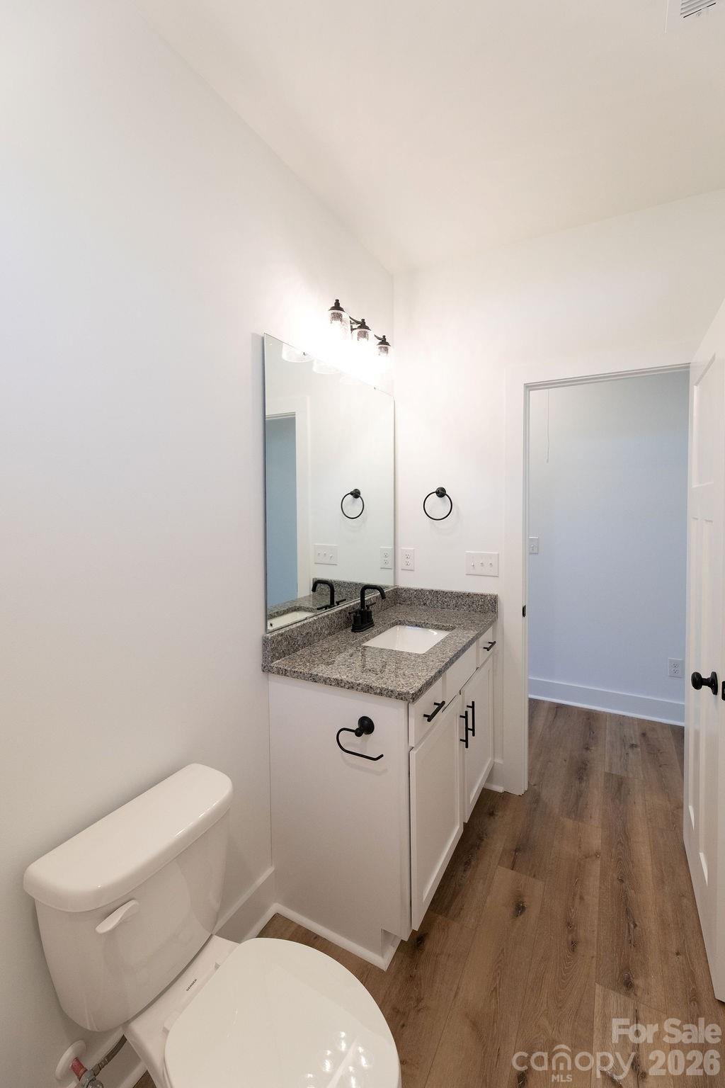 4018 Deerstone Lane Clover, SC 29710 - Photo 28 of 35 a spacious bathroom with a granite countertop sink a toilet and a mirror