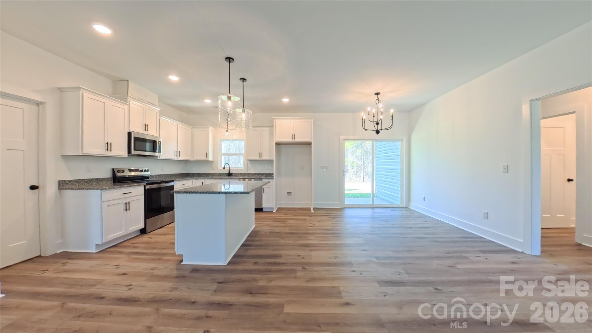 4018 Deerstone Lane Clover, SC 29710 - Photo 5 of 35 a large kitchen with granite countertop a large counter top a sink stainless steel appliances and cabinets