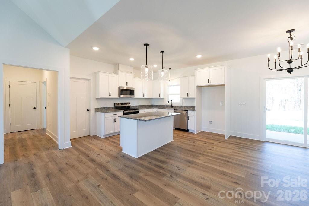 4018 Deerstone Lane Clover, SC 29710 - Photo 7 of 35 a kitchen with granite countertop a refrigerator and a stove top oven