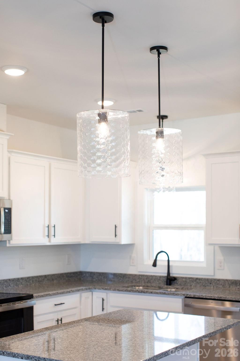 4018 Deerstone Lane Clover, SC 29710 - Photo 9 of 35 a kitchen with a sink and chandelier