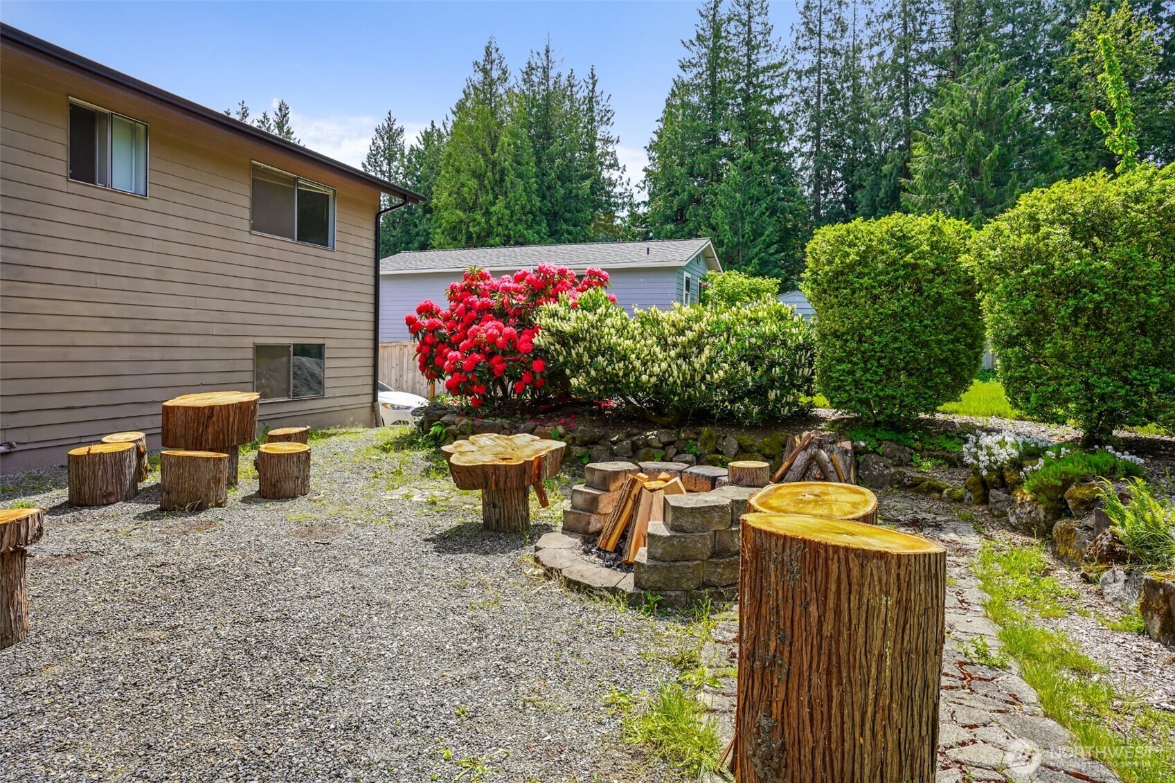 16604 3rd Avenue Southeast Bothell, WA 98012 - Photo 20 of 22 a view of a chairs and table in the back yard of the house