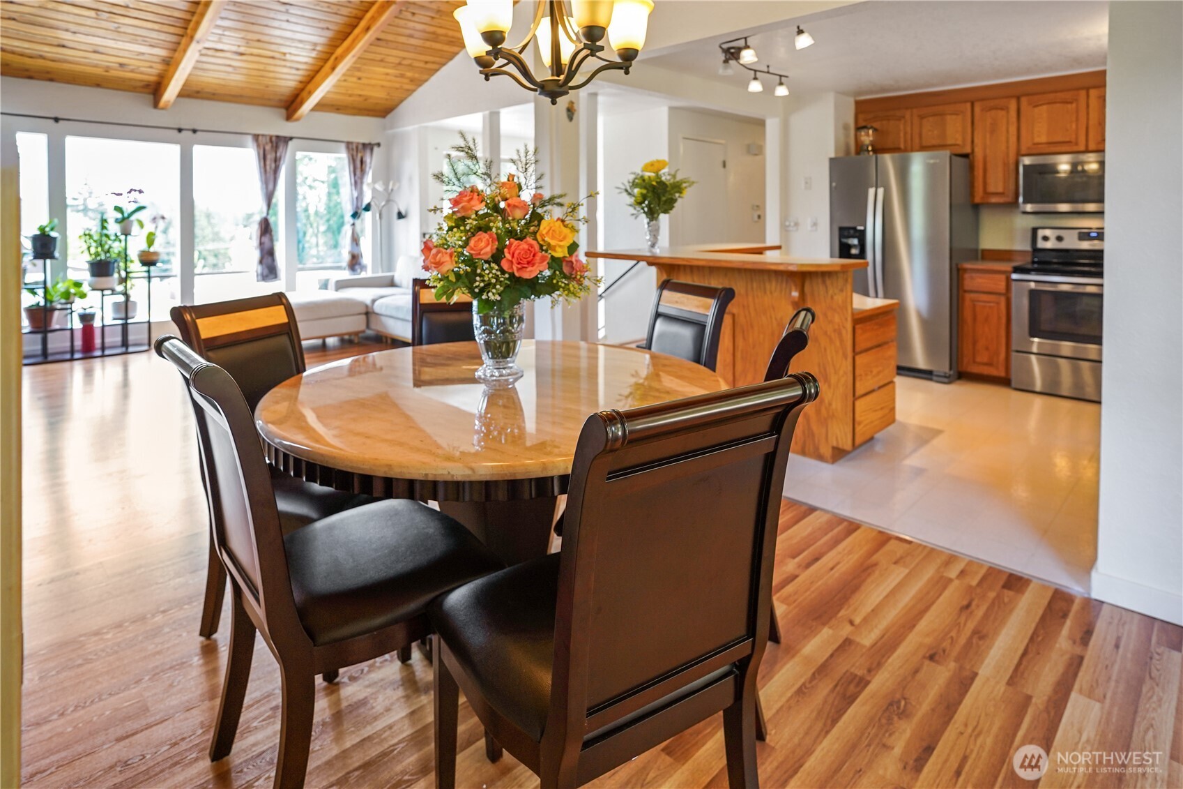 16604 3rd Avenue Southeast Bothell, WA 98012 - Photo 6 of 22 a dining room with furniture a potted plant and wooden floor